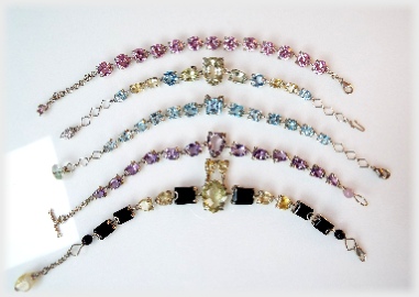5 Mixed Faceted Gemstone Bracelets in silver, with and without centerstones.